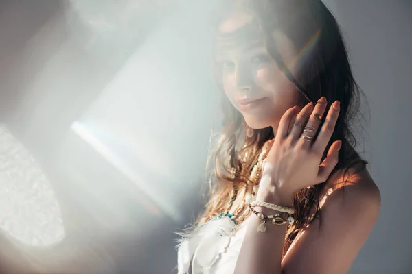 Happy naked boho girl with braids in hairstyle posing on grey with lens flares — Stock Photo