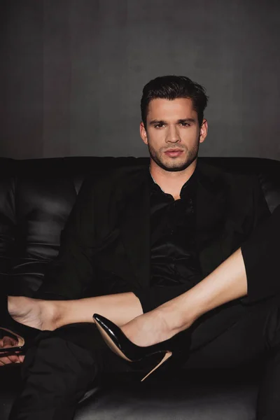 Cropped view of woman and handsome man looking at camera isolated on black — Stock Photo