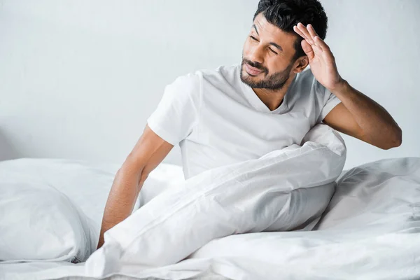Handsome bi-racial man waking up and looking away in morning — Stock Photo