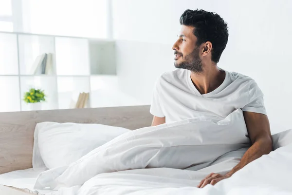 Handsome and smiling bi-racial man looking away in morning — Stock Photo