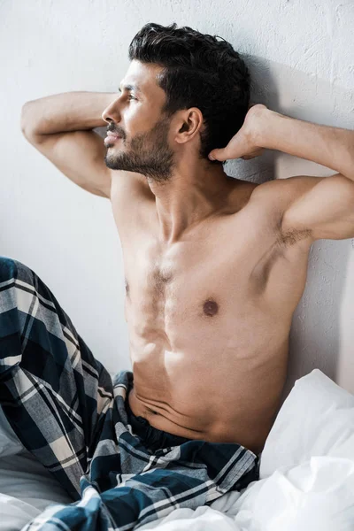 Handsome and sexy bi-racial man with hands on head in morning — Stock Photo