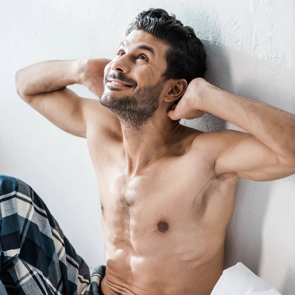 Handsome and sexy bi-racial man with hands on head smiling in morning — Stock Photo