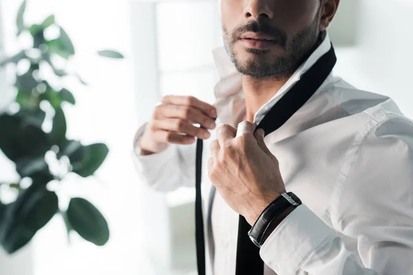 Cropped view of bi-racial man dressing up in morning — Stock Photo