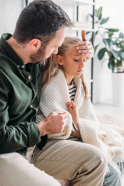 Worried father touching forehead of diseased daughter — Stock Photo