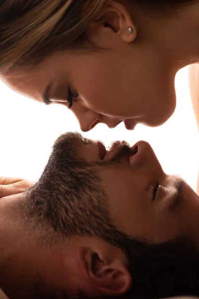 Close up of beautiful tender couple going to kiss, isolated on white — Stock Photo