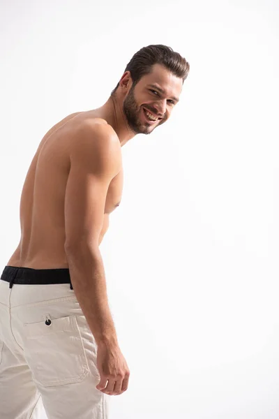 Uomo felice senza maglietta in jeans bianchi, isolato su bianco — Foto stock