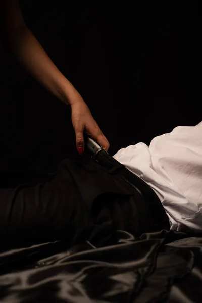 Cropped view of sexy couple lying in bed in dark room — Stock Photo