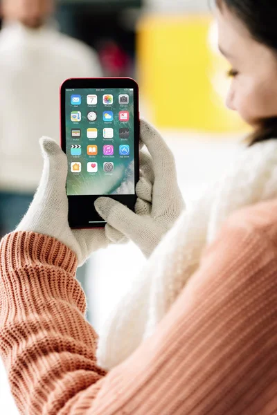 KYIV, UKRAINE - 15 NOVEMBRE 2019 : vue recadrée d'une femme portant des gants et tenant un smartphone — Photo de stock