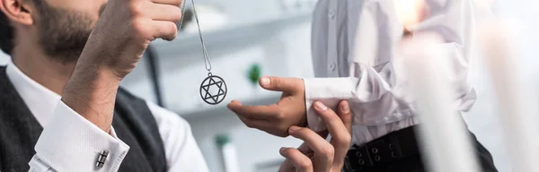 Panoramic shot of jewish father giving star of david necklace to son in apartment — Stock Photo