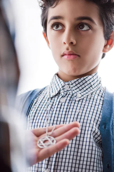 Cropped view of jewish father holding star of david necklace on son — Stock Photo