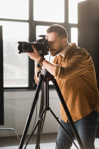 Photographer taking photo with digital camera on backstage — Stock Photo