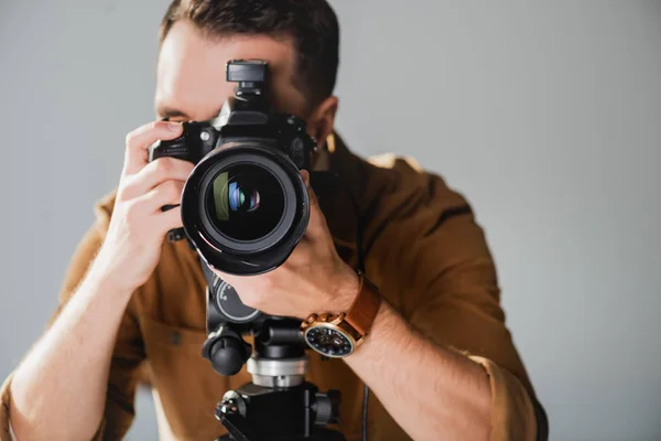 Selective focus of photographer taking photo with digital camera on backstage — Stock Photo