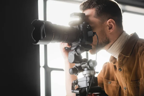 Photographer taking photo with digital camera on backstage — Stock Photo