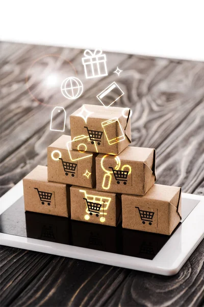 Toy carton boxes on digital tablet near illustration, e-commerce concept — Stock Photo