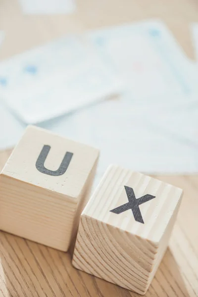 Selective focus of letters ux on wooden cubes on table — Stock Photo