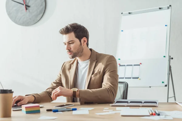 Selective focus of creative designer working at laptop with ux applications on table — Stock Photo