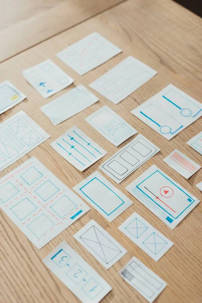 High angle view of layouts of user experience design on wooden table — Stock Photo