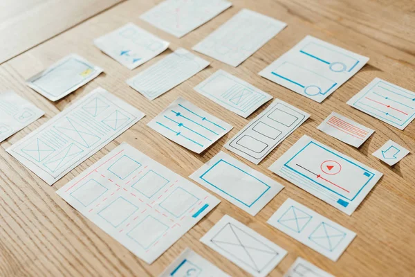High angle view of web sketches for user experience design on wooden table — Stock Photo
