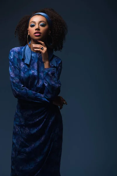 Attractive african american woman looking at camera isolated on blue — Stock Photo