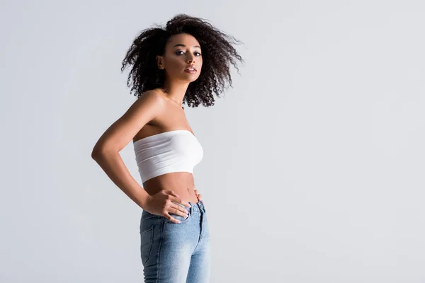 African american woman in white top isolated on grey — Stock Photo