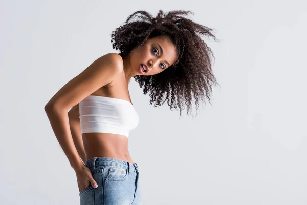 African american woman in white top isolated on grey — Stock Photo