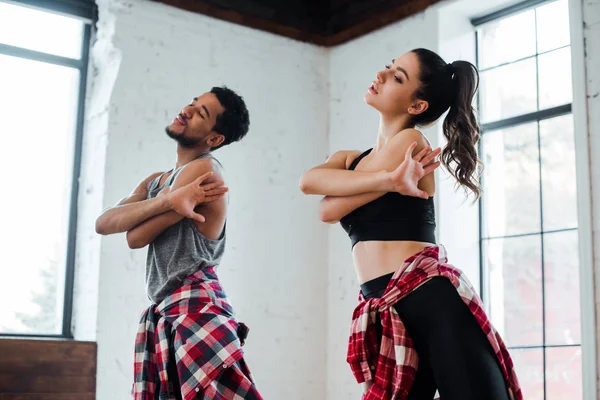 Pretty girl and handsome african american man dancing jazz funk — Stock Photo