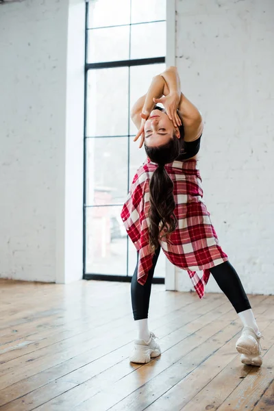 Attractive girl dancing jazz funk in dance studio — Stock Photo