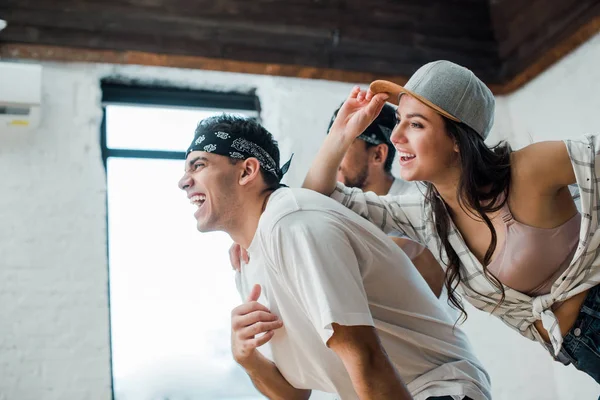 Selective focus of cheerful multicultural dancers posing in dance studio — Stock Photo