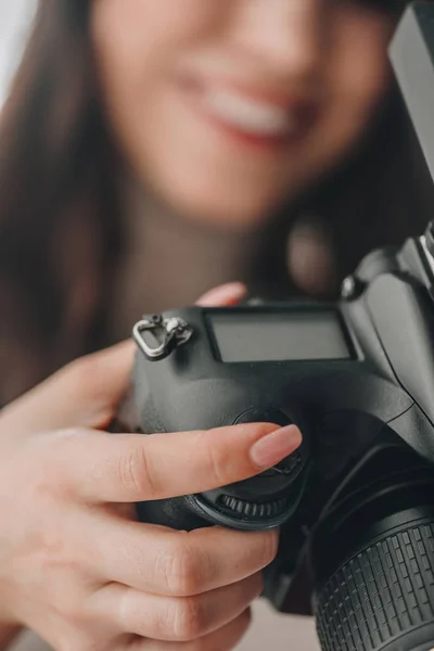 Selective focus of art editor holding digital camera — Stock Photo