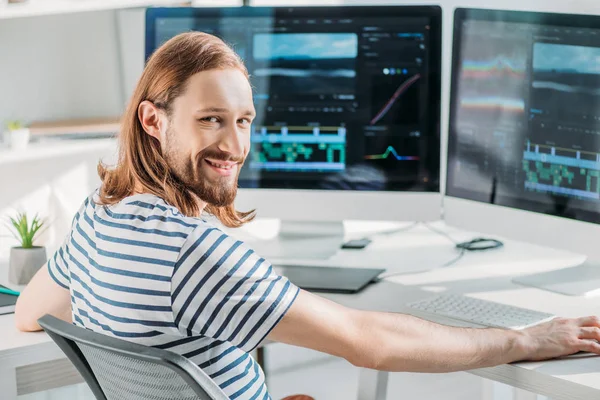 Cheerful bearded art editor working in studio — Stock Photo