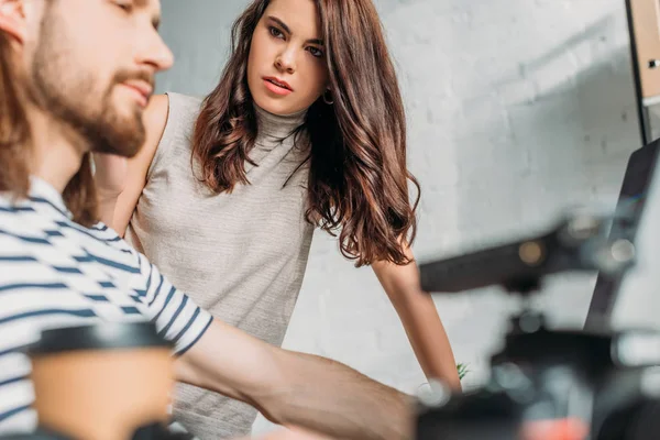 Selective focus of attractive editor looking at bearded coworker — Stock Photo