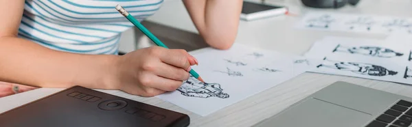 Panoramic shot of illustrator drawing sketches in studio — Stock Photo