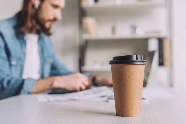 Selective focus of paper cup near animator — Stock Photo