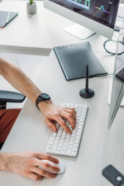 Cropped view of art editor using computer keyboard while typing in studio — Stock Photo