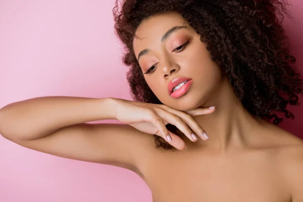 Portrait of beautiful tender african american girl with perfect skin, isolated on pink — Stock Photo