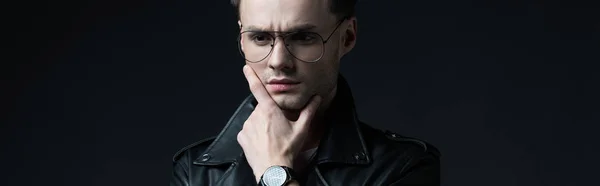 Tense thoughtful stylish brutal man in biker jacket isolated on black, panoramic shot — Stock Photo