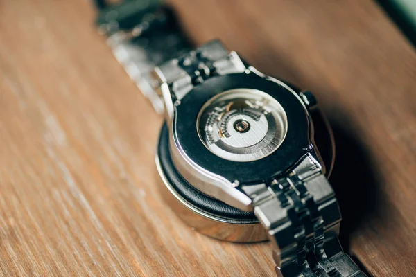 Close up view of mechanical wristwatch on stand on wooden table — Stock Photo