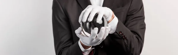 Cropped view of professional magician holding magic ball, isolated on grey, panoramic shot — Stock Photo