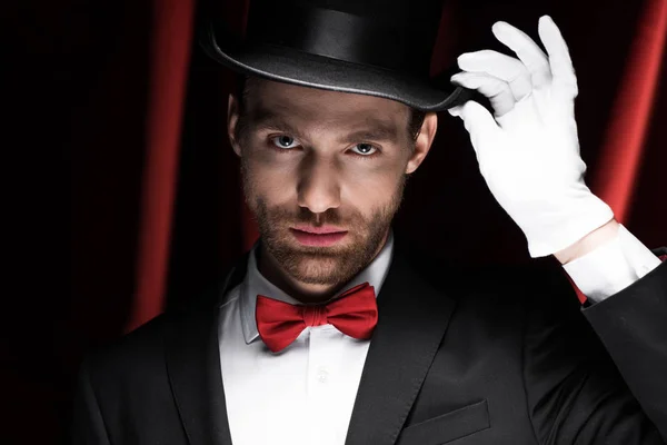 Beau monsieur en costume et chapeau dans le cirque avec des rideaux rouges — Photo de stock