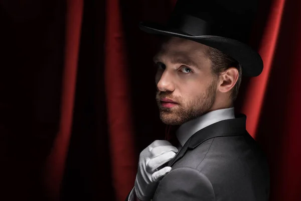 Caballero guapo en circo con cortinas rojas - foto de stock