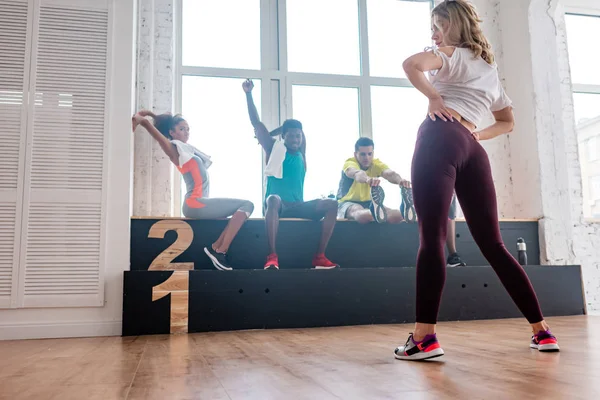 Selective focus of multicultural zumba dancers warming up in dance studio — Stock Photo