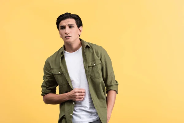 Worried man in casual clothes, isolated on yellow — Stock Photo