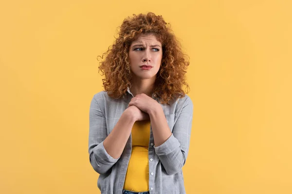 Upset beautiful redhead woman isolated on yellow — Stock Photo