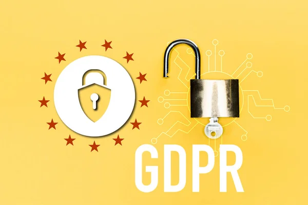 Top view of locker with key near gdpr lettering on yellow — Stock Photo