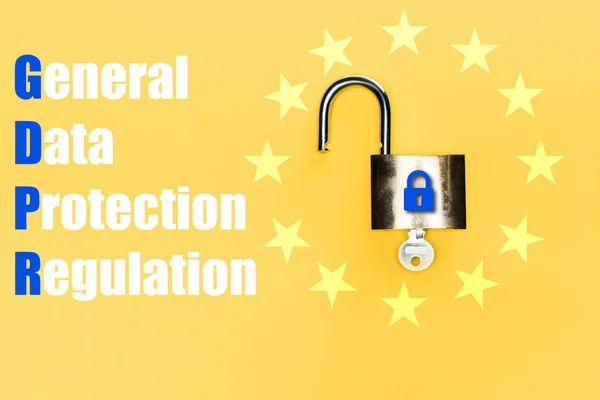 Top view of locker with key near blue gdpr lettering on yellow — Stock Photo