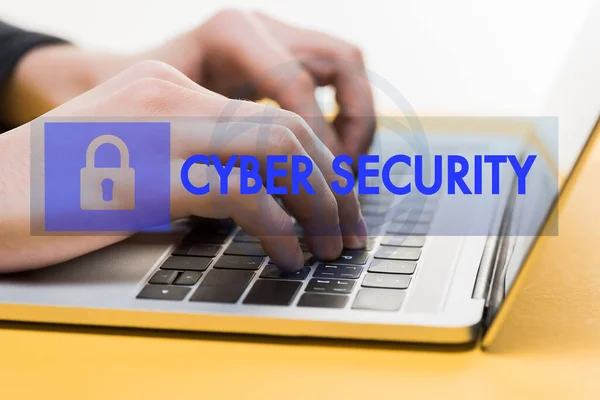 Close up of hacker using laptop near cyber security lettering on white — Stock Photo