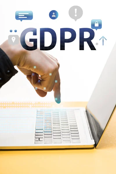 Cropped view of man pointing with finger at laptop near gdpr lettering on white — Stock Photo