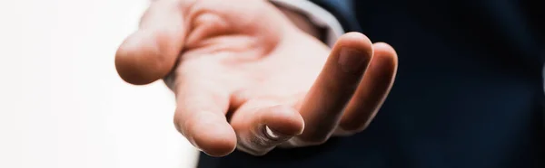 Panoramic shot of businessman with outstretched hand isolated on white — Stock Photo