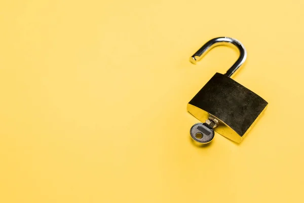 Metallic locker with key isolated on yellow — Stock Photo