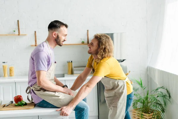 Profile of happy homosexual men looking at each other — Stock Photo